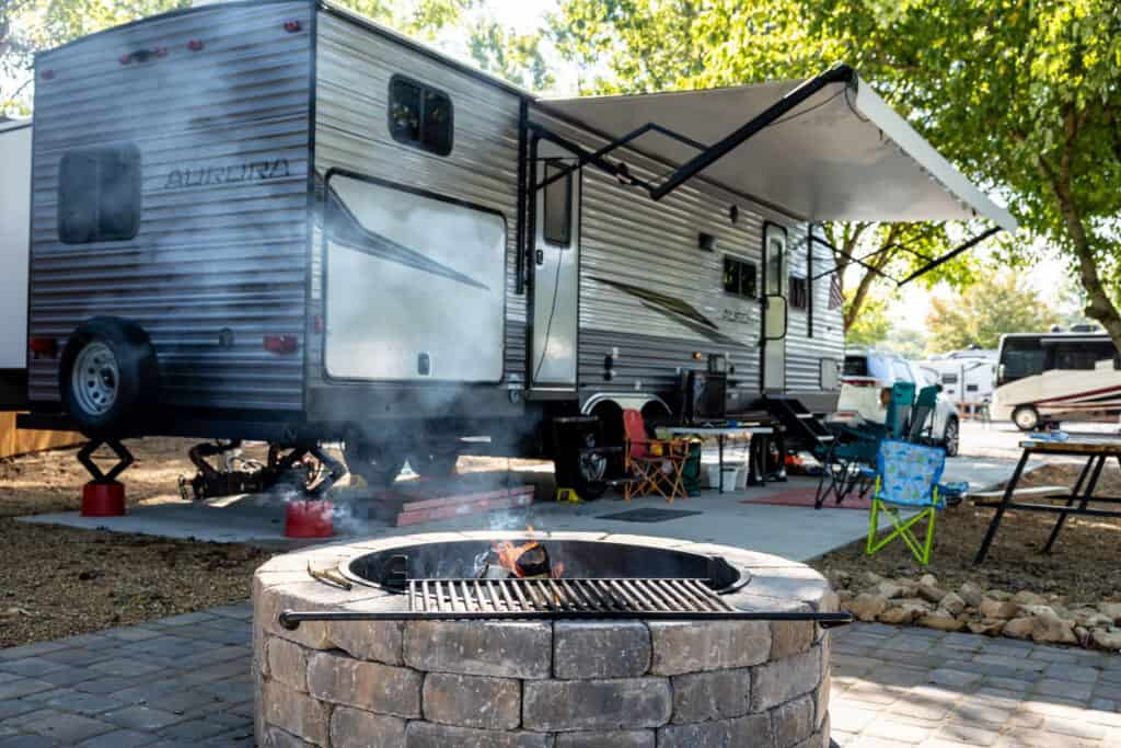 An RV parked at Big Meadows Campground next to a fire pit.