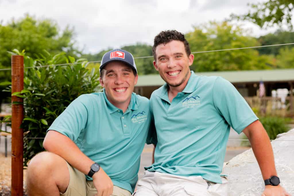 Two men in blue polo shirts posing for a photo.