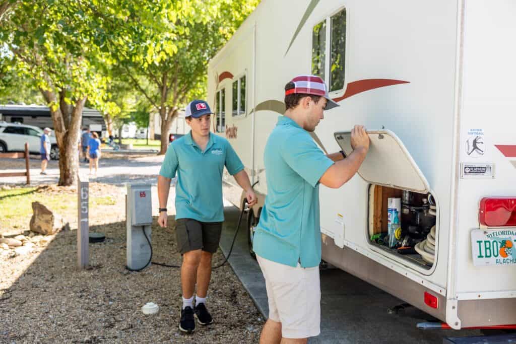 Two men standing next to an rv.