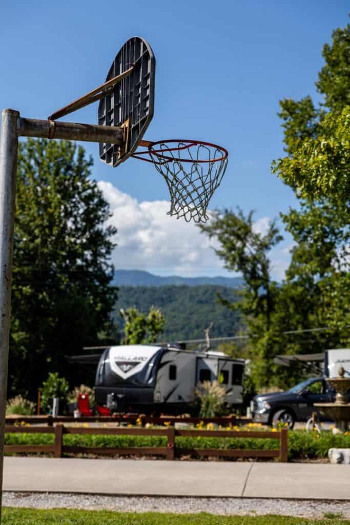 A basketball hoop in front of an rv park.
