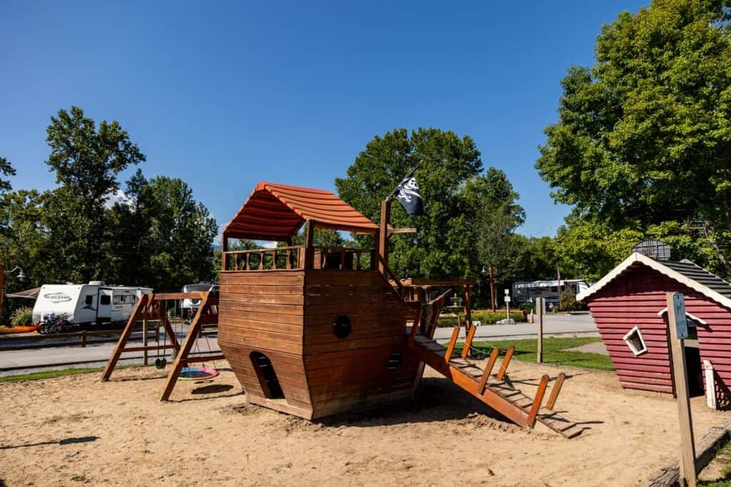 A wooden pirate ship in the sand.