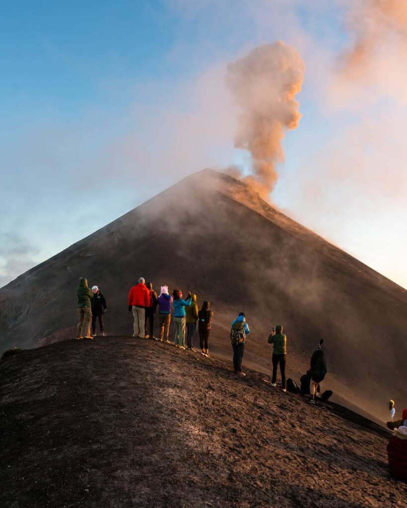 A group of hikers waiting to see Volcan Fuego irrupt in front of them