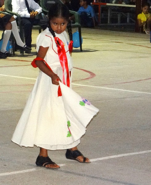 A young solo performer shyly enchants the crowd with her dance..