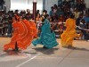 Colorful dance costumes brighten the hot desert landscape.