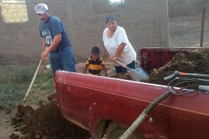 family unloads compost-enriched soil