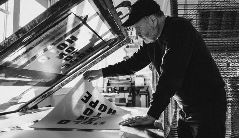 Anthony Burrill's four giant letters, the branding move that made Glastonbury a beacon of hope