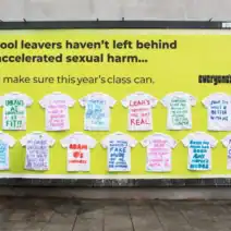 London billboard, covered in signed leavers' shirts, shows messages that defy expectations