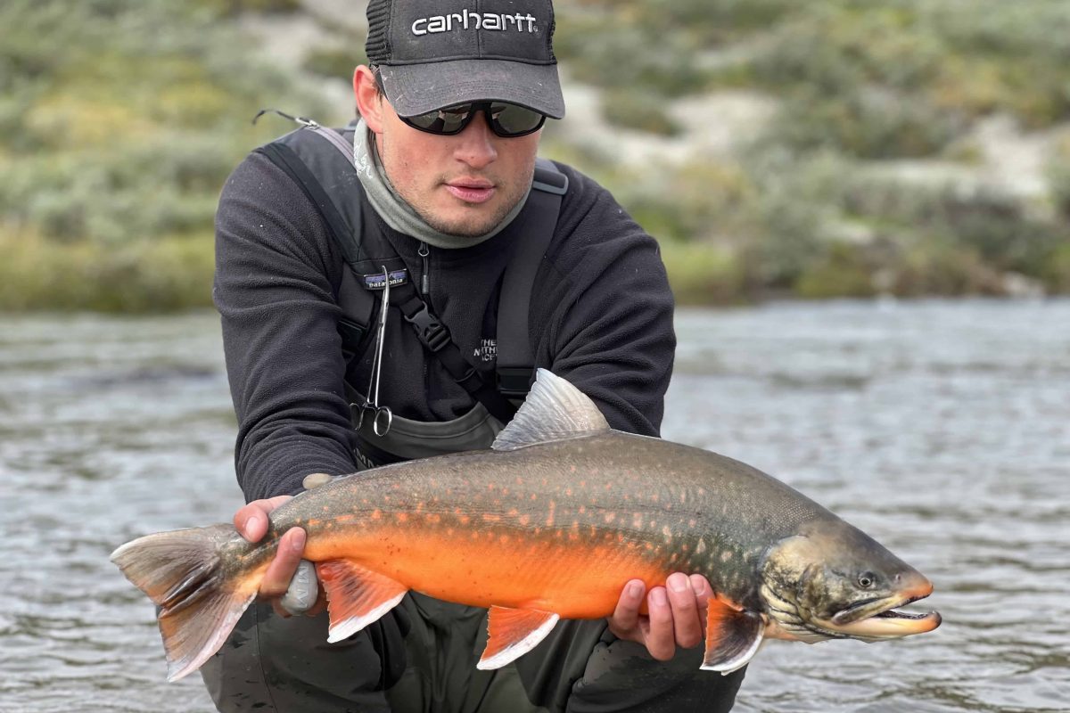 Angler holding arctic char in greenland