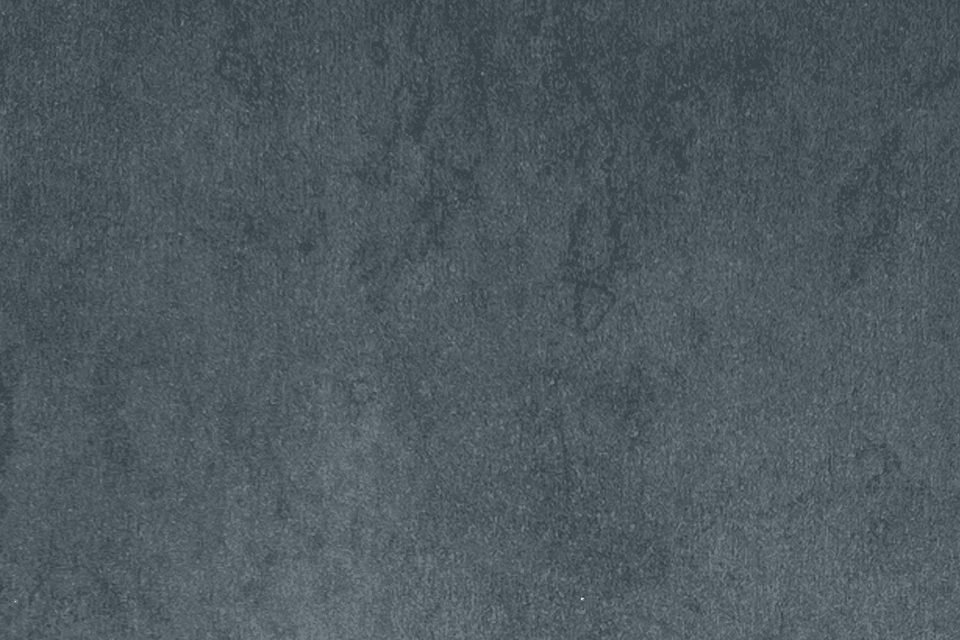 En grå, texturerad betongvägg.