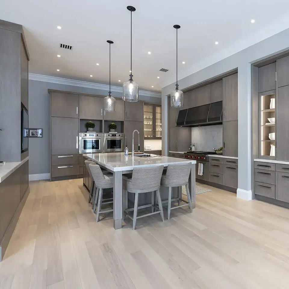 Contemporary kitchen with gray cabinetry and a central island, emphasizing style and practicality in a spacious layout.