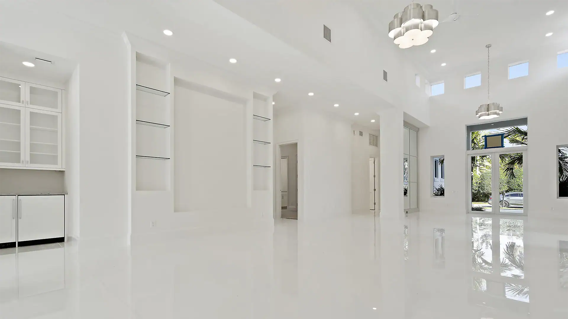 Refined white passageway showcasing a magnificent glass door.