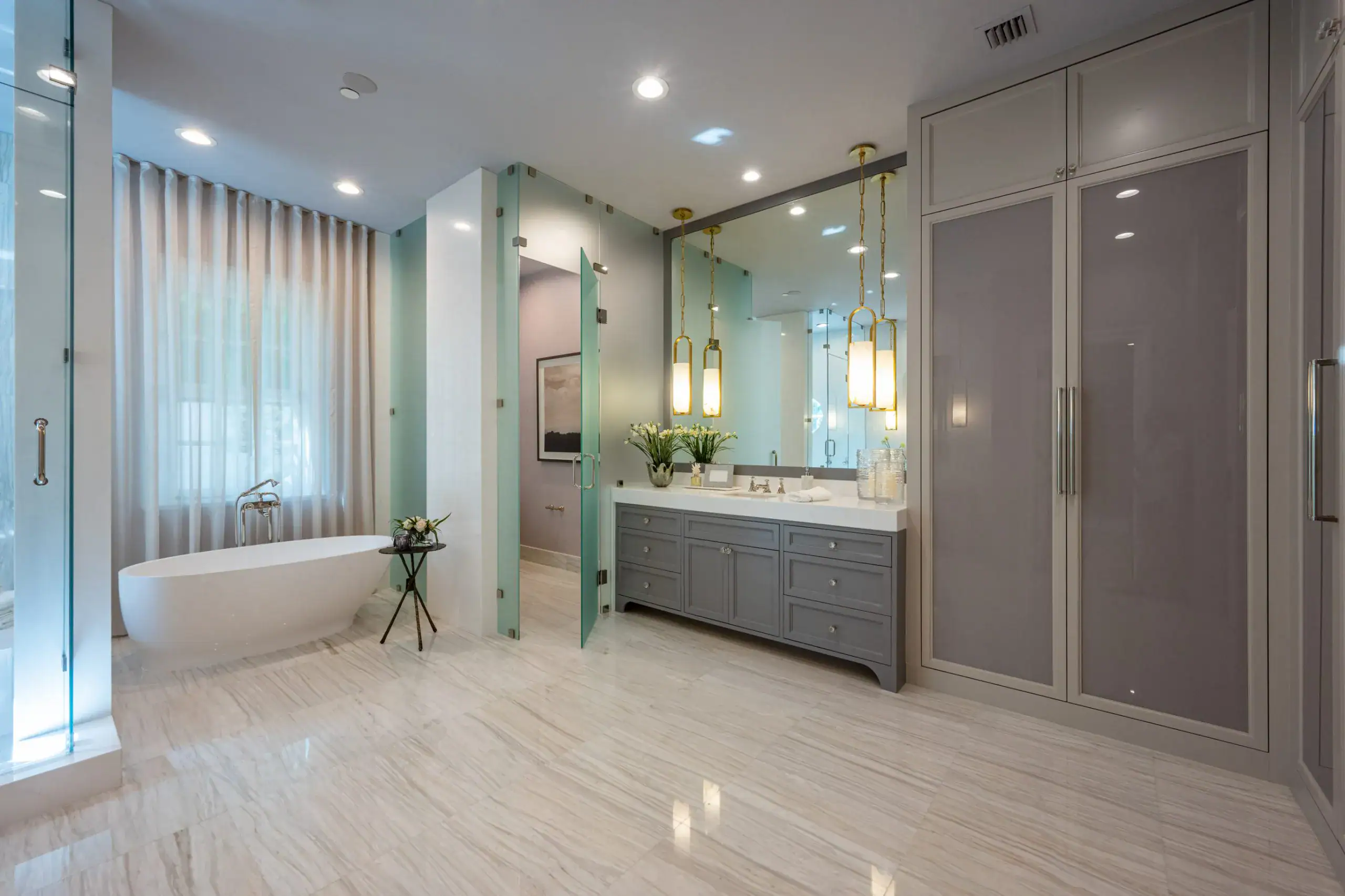 Bathroom showcasing a large white tub, a sleek glass shower, and soft lighting for a tranquil retreat.