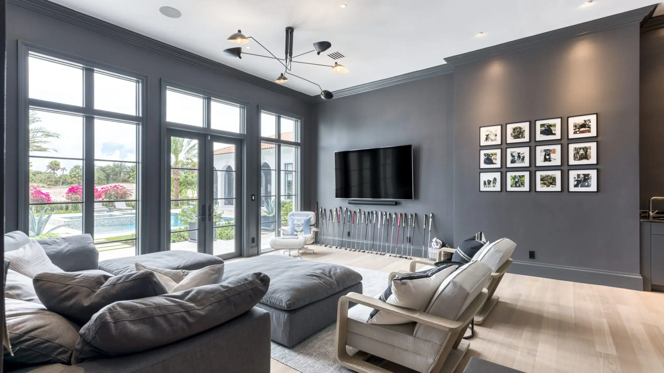 Modern living room featuring gray walls and a television.