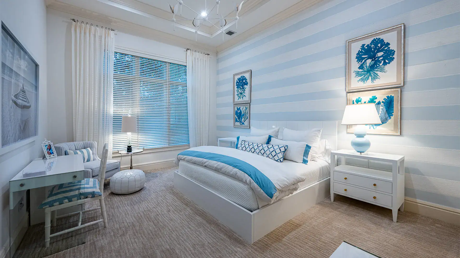 Tranquil bedroom featuring blue and light blue striped walls, complemented by white and cream accents.