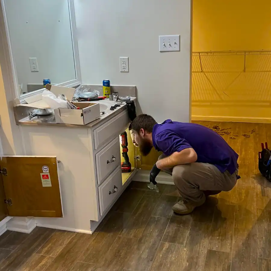 Home-Heroes-Plumbing-Heating-And-Air-Technician-Installing-Bathroom-Vanity
