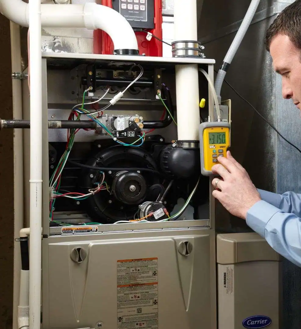 HVAC-Technician-Diagnosing-Carrier-Furnace-With-Digital-Meter