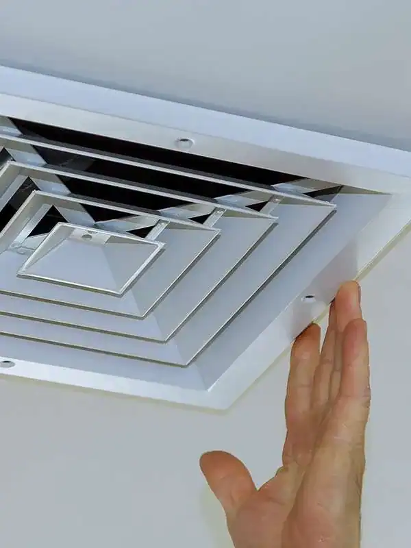 Technician-Adjusting-Ceiling-HVAC-Air-Vent-Register