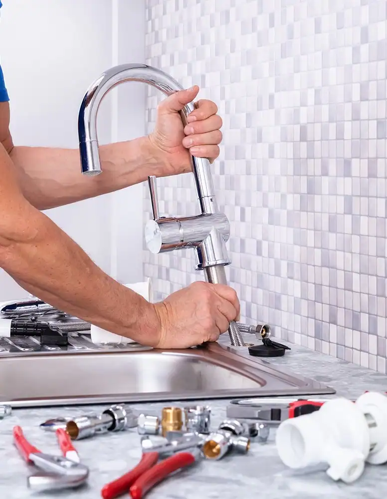 Plumber-Installing-Kitchen-Faucet-With-Plumbing-Tools