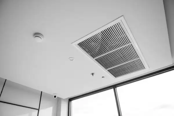 Clean-White-Ceiling-Air-Vent-With-Smoke-Detector