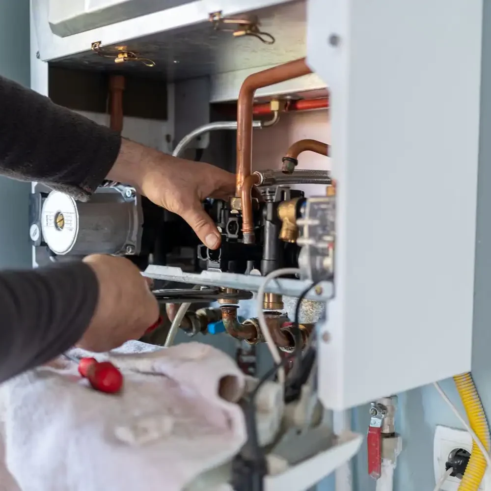 HVAC-Technician-Servicing-Furnace-Copper-Pipe-Components