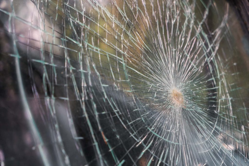 A spiderweb with a central point of damage, showcasing intricate web design.
