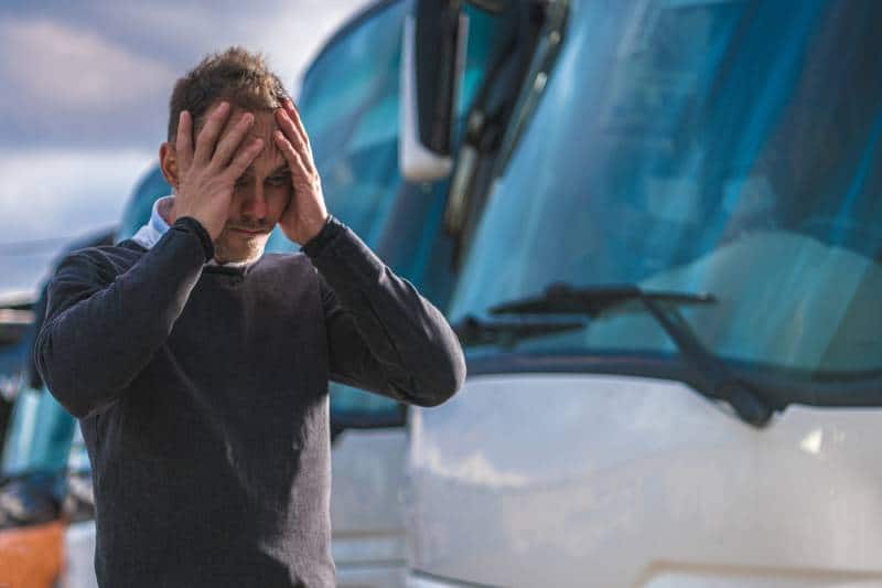 Man holding his head after a truck accident in Arizona.