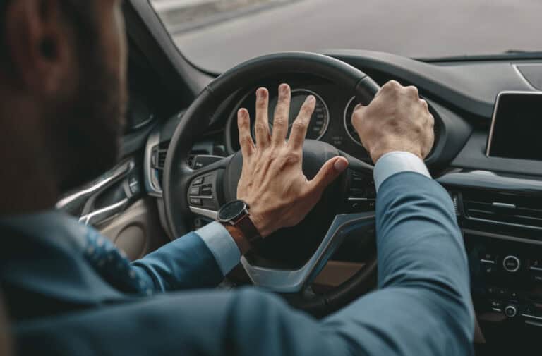 Driver showing aggressive driving behavior behind the wheel.