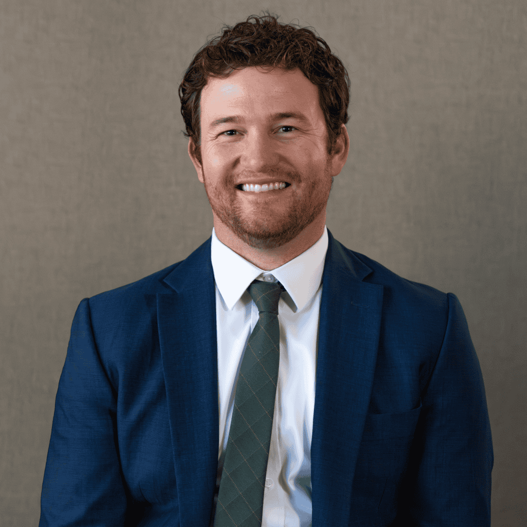 Professional lawyer in blue suit smiling for legal consultation in Arizona.