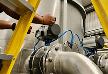 An EMVAfrica technician working on a butterfly valve to ensure the flow is regulated of abrasive slurries and to control the discharge of tailing.