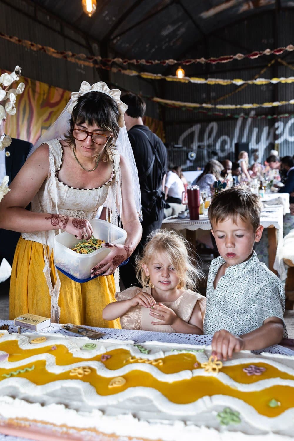 Photography of a yellow DIY wedding in a barn by London photographer Lauren Squire