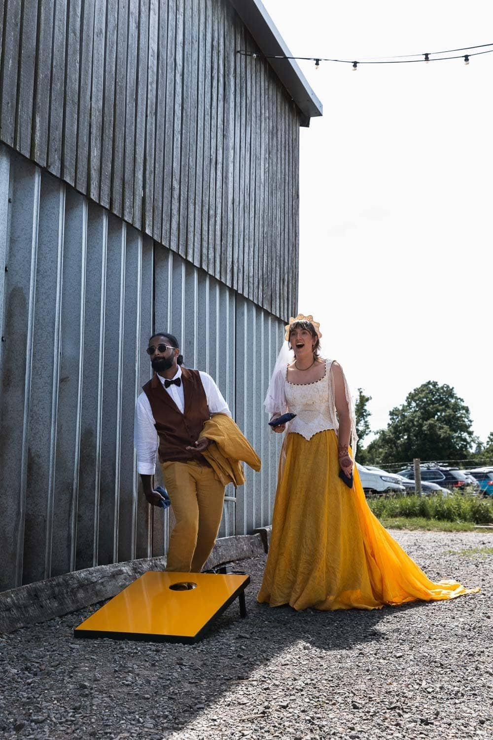 Photography of a yellow DIY wedding in a barn by London photographer Lauren Squire