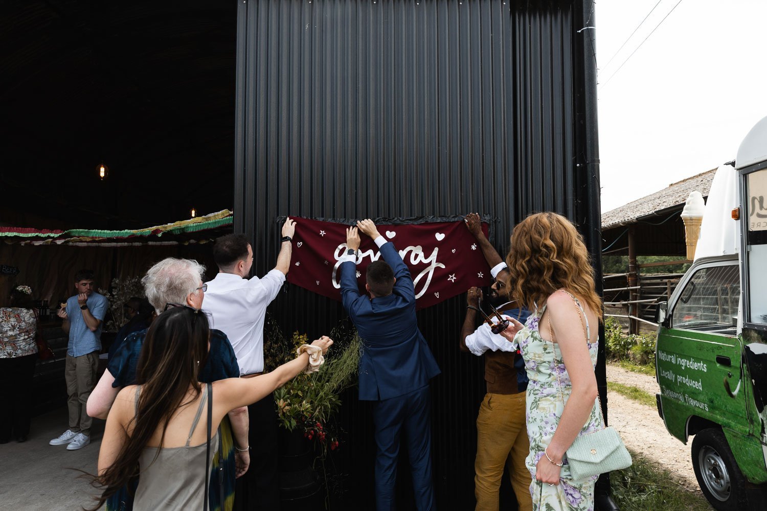 Photography of a yellow DIY wedding in a barn by London photographer Lauren Squire