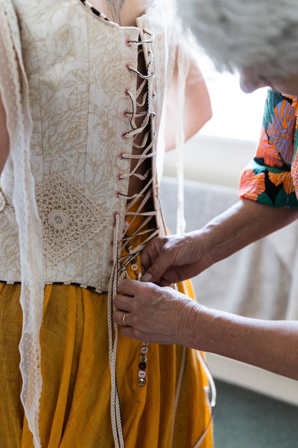 Photography of a yellow DIY wedding in a barn by London photographer Lauren Squire