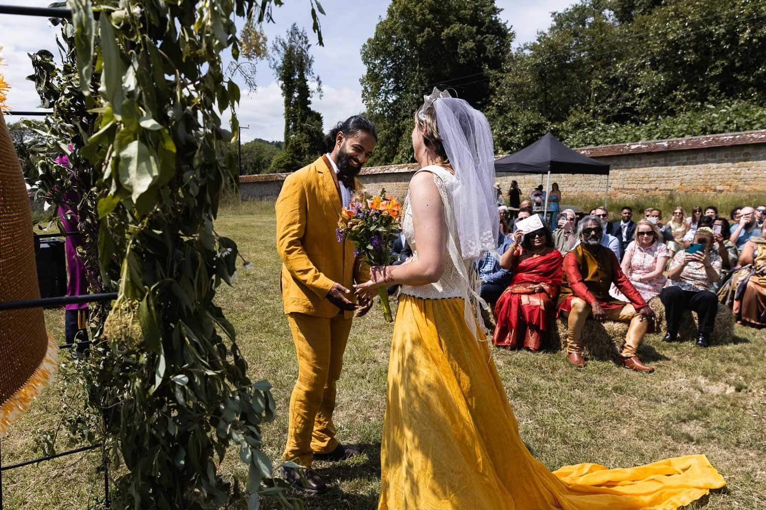Photography of a yellow DIY wedding in a barn by London photographer Lauren Squire