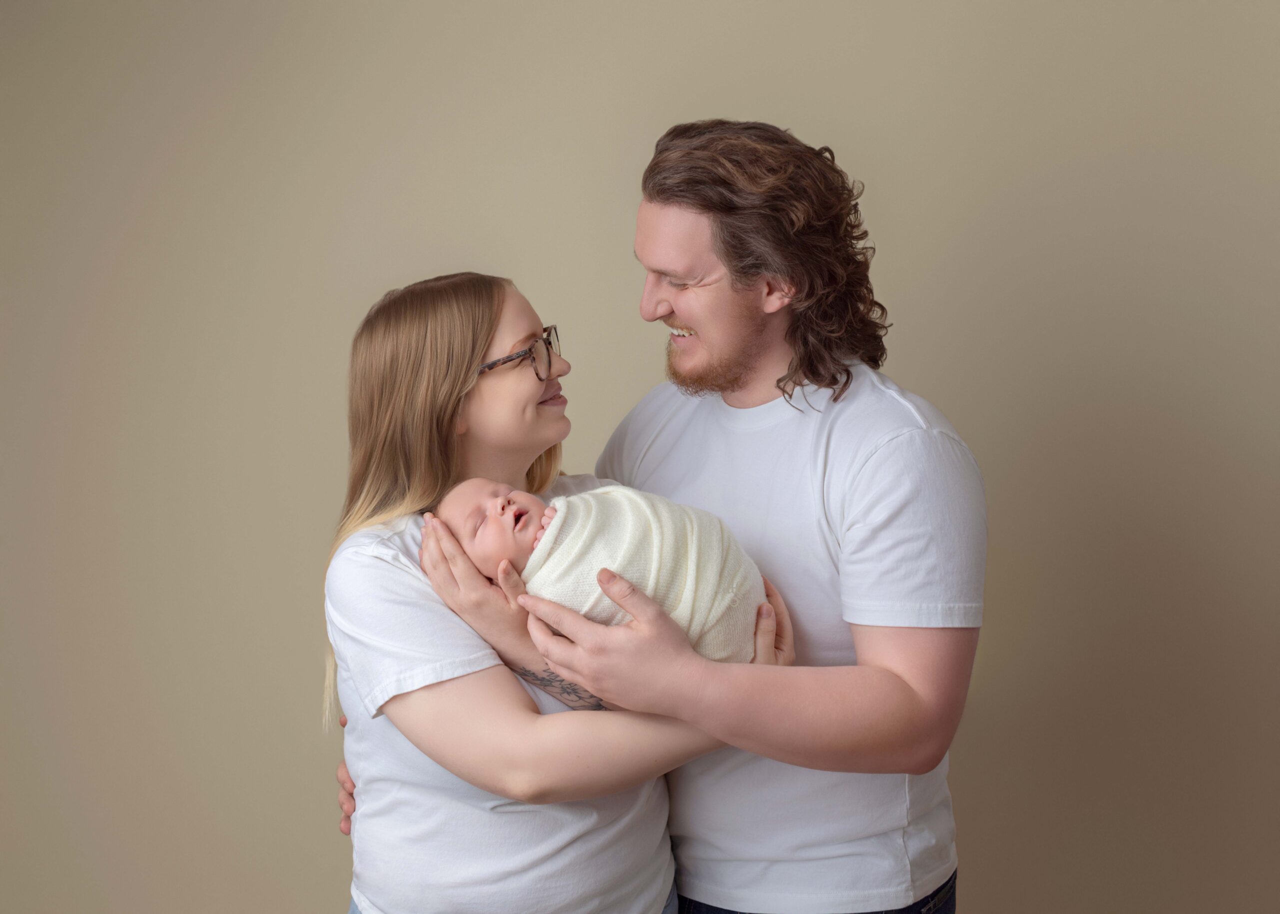 Parents hold their newborn baby for newborn and family photoshoot in EDmonton