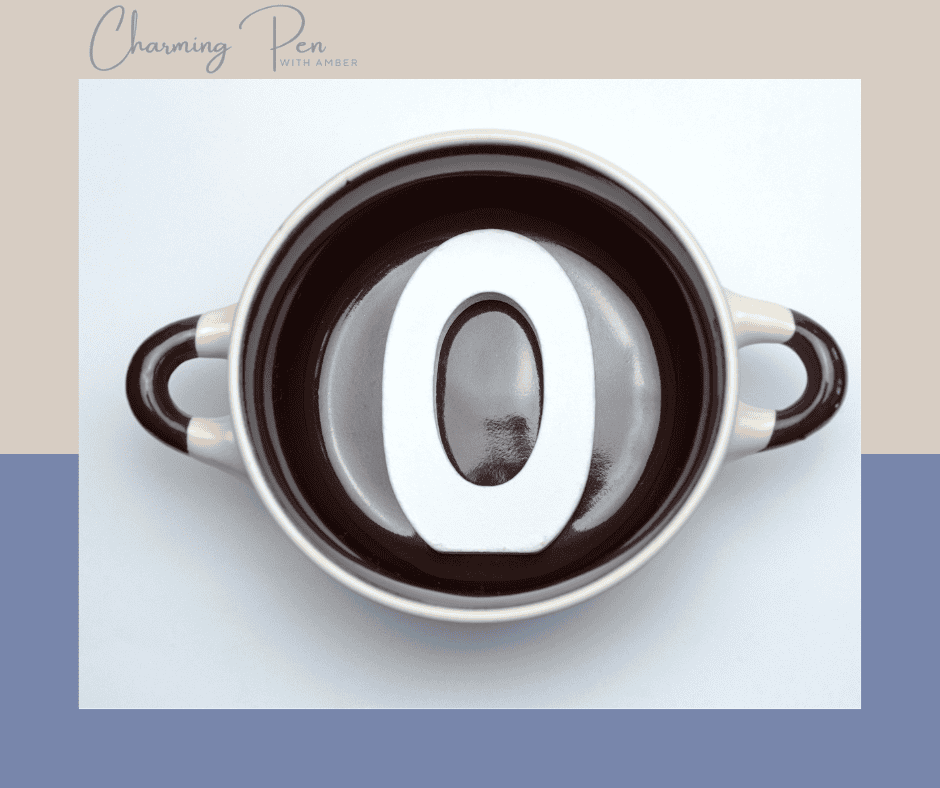 a soup mug with a large white zero in the bottom
