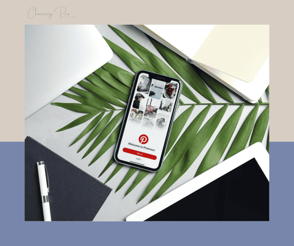 Pinterest on mobile phone lays on palm fronds