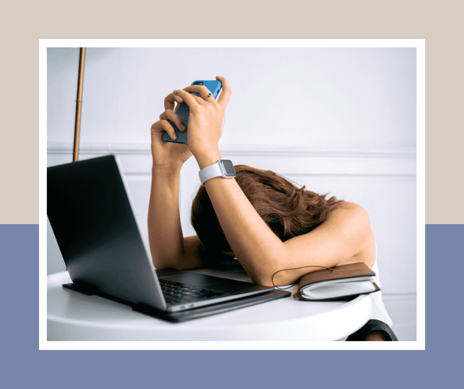 woman face down on table in front of open laptop