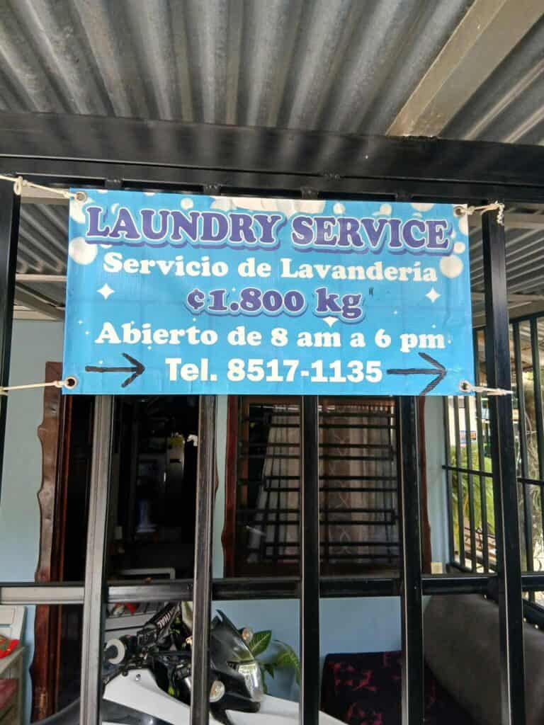 Laundry service sign in Santa Teresa showing price per kilo