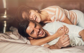 happy-young-couple-in-bed-royalty-free-image-686509338-1531465728
