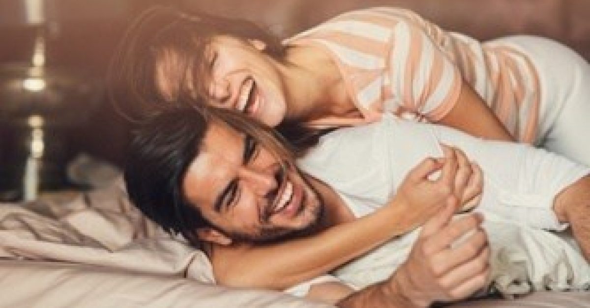 happy-young-couple-in-bed-royalty-free-image-686509338-1531465728