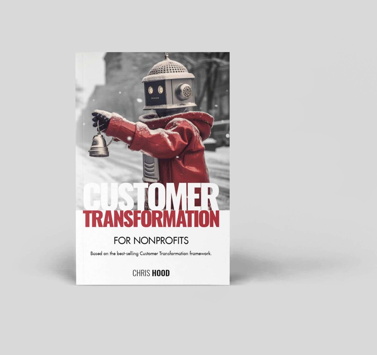 A robot with a vintage head holding a small bell, dressed in a red jacket, standing outdoors on a snowy day promoting "Customer Transformation" for nonprofits by Chris Hood.
