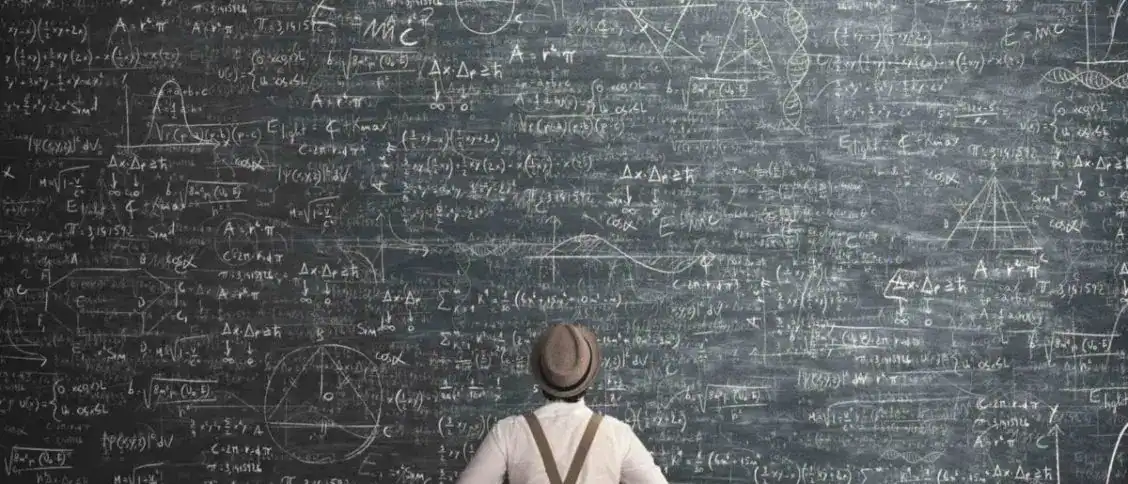 A person standing in front of a large blackboard filled with complex mathematical formulas and equations, representing advanced learning and scientific research.