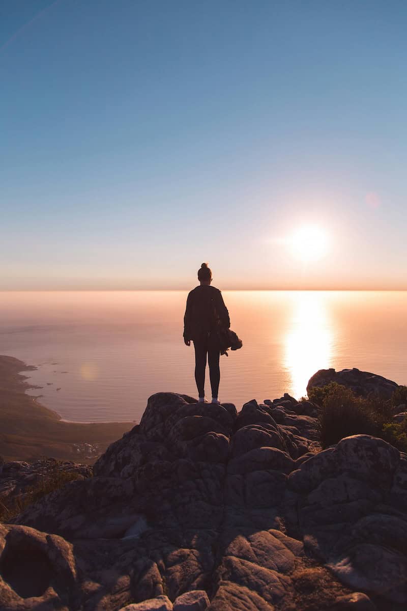 A woman standing in a sunset
