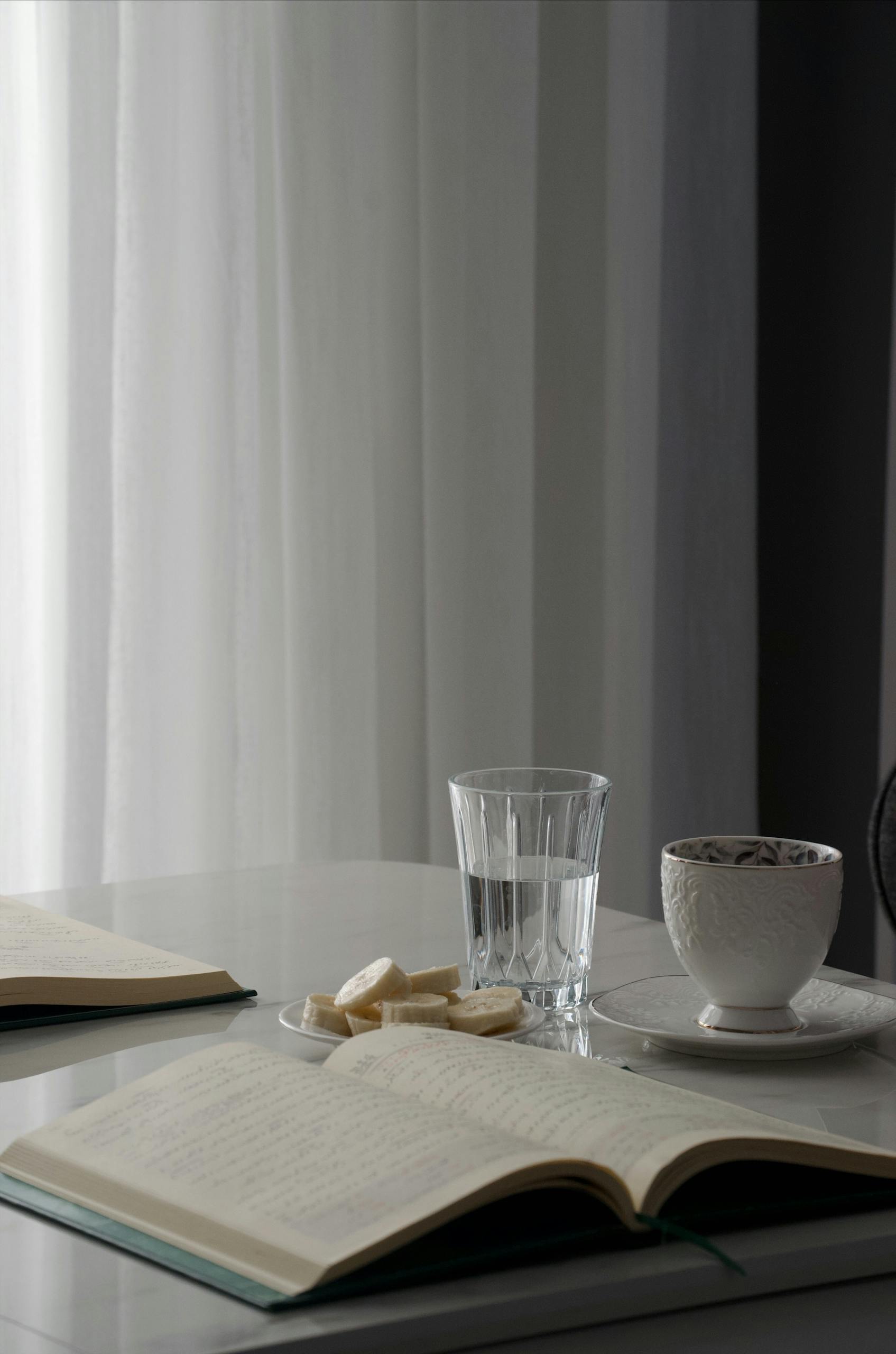 A serene setup with books, tea, and biscuits for a time to reflect on journal prompts for mental health.