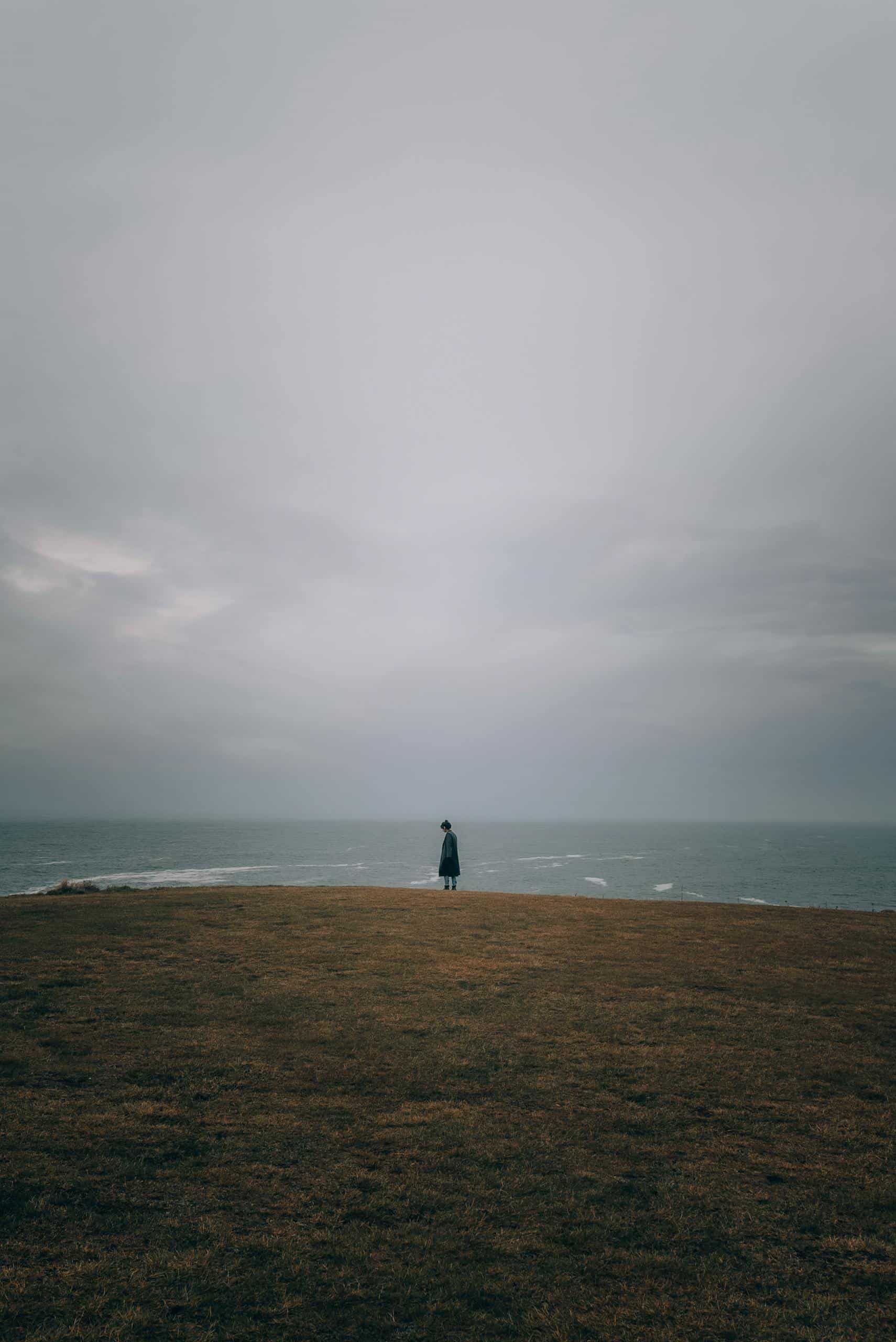 A person walking alone on a beach, representing healing from a narcissistic parent