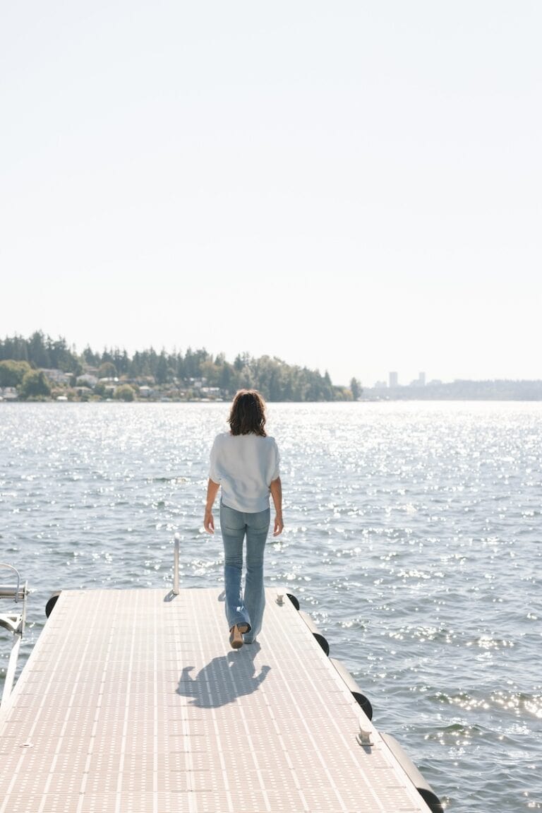 Person standing quietly in nature using grounding techniques to cope with trauma triggers