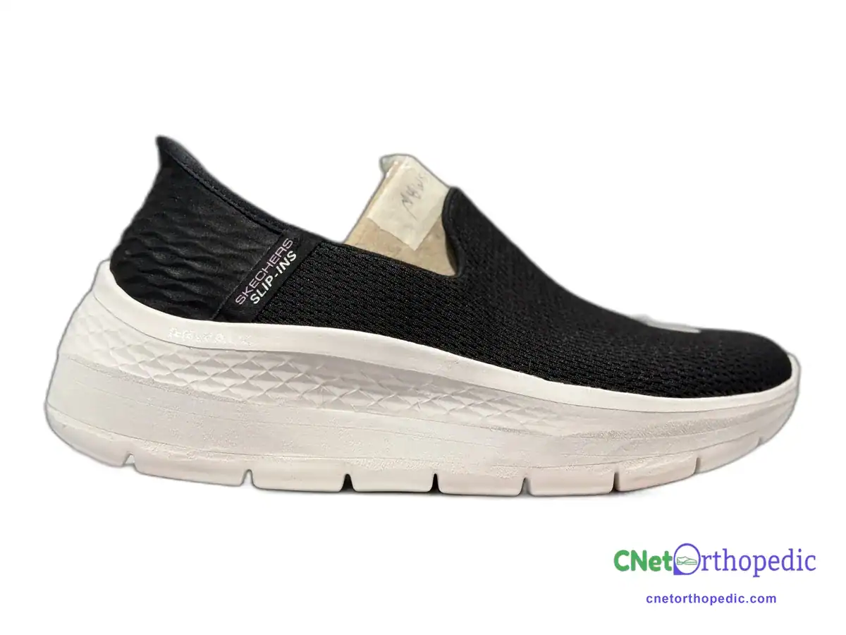 Black Skechers slip-on sneaker with a 1 inch white sole lift
