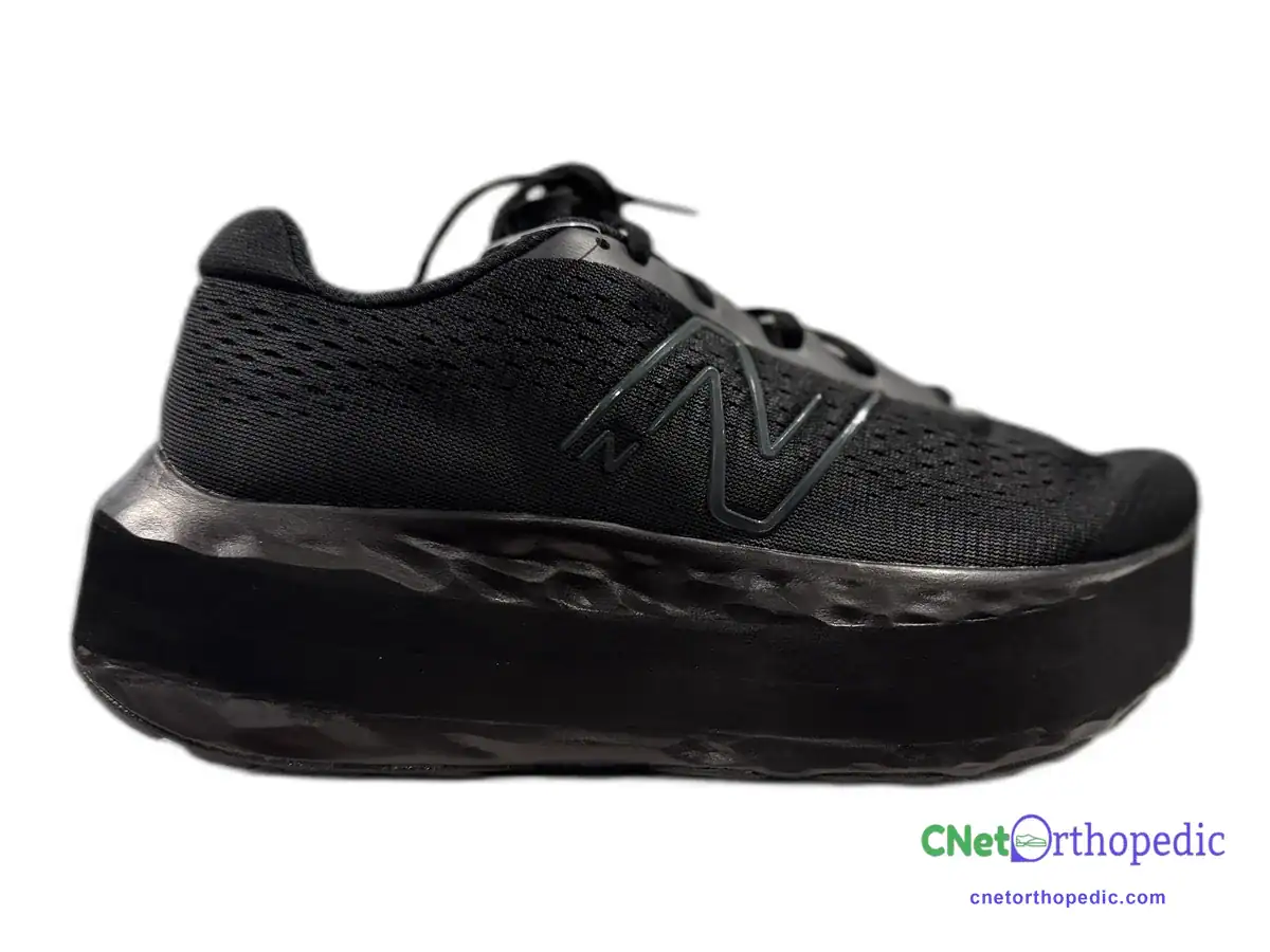 Black New Balance sneaker with a 2 inch black shoe lift