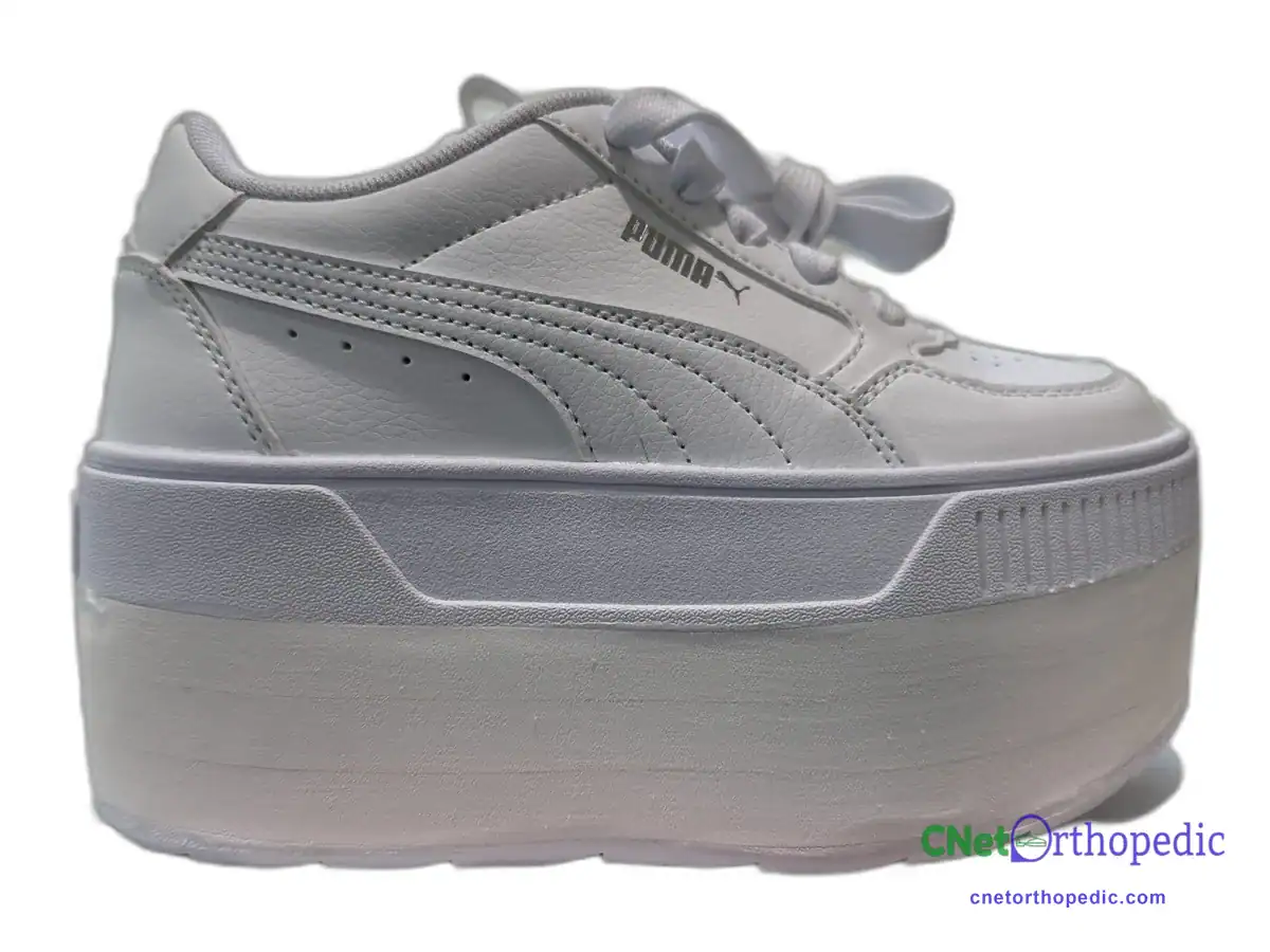 White Puma sneaker with a 2.5 inch shoe lift built into the sole